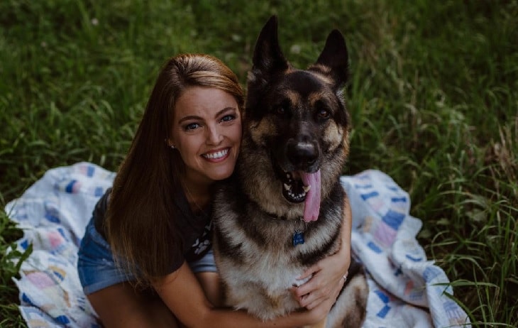 German Shepherd Sitting With Its Owner.