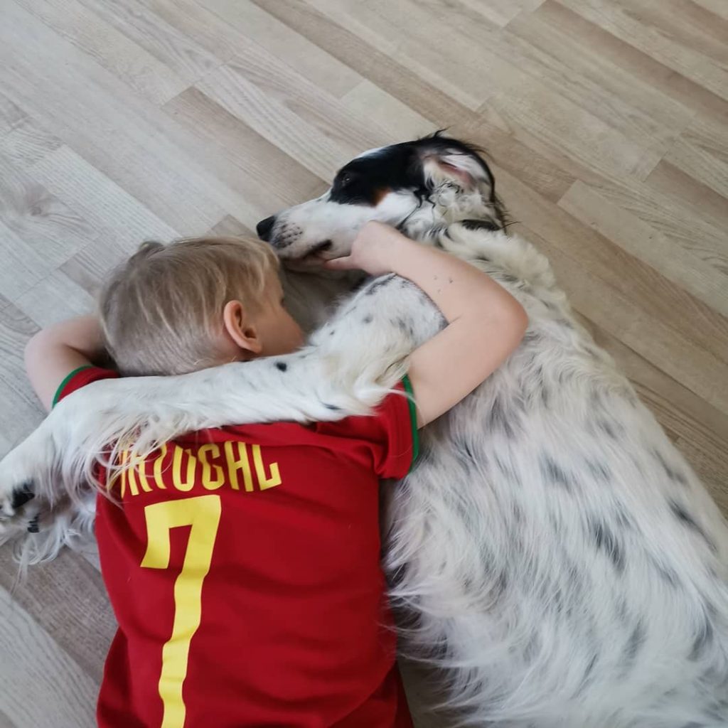 English Setter Sleeping With A Child.