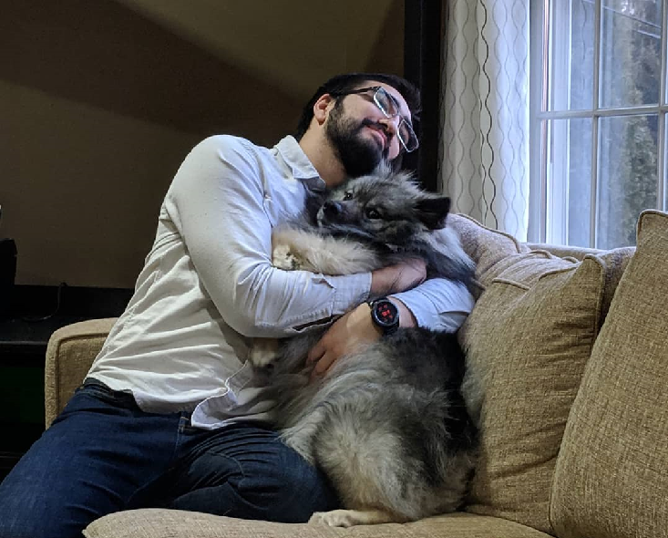 Keeshond Huggind Its Owner.