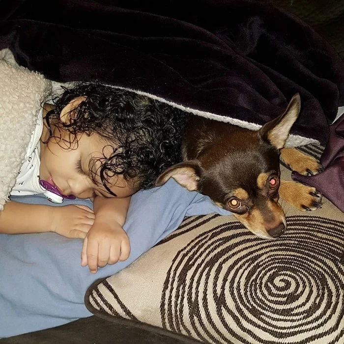 Jack Chi laying down with a baby girl